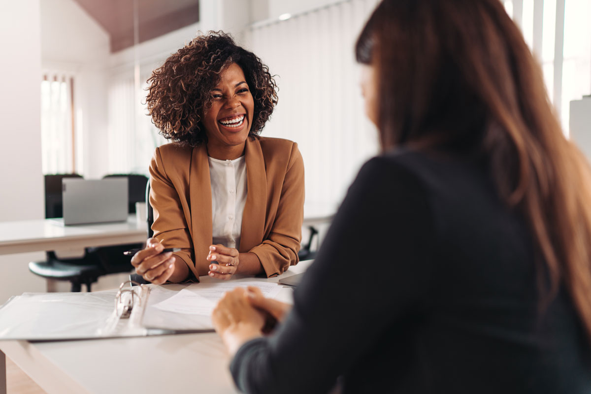 An EAP service consultant smiling and chatting face-to-face.