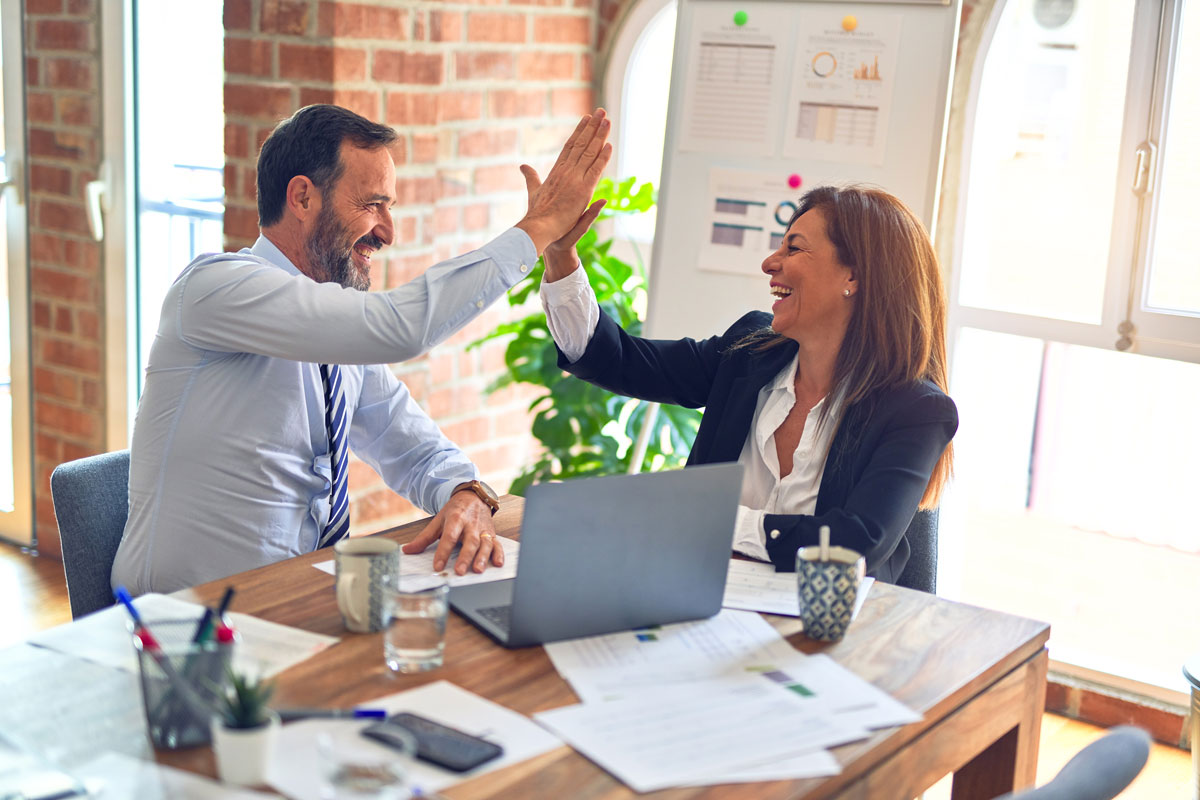 Two colleagues high-fiving