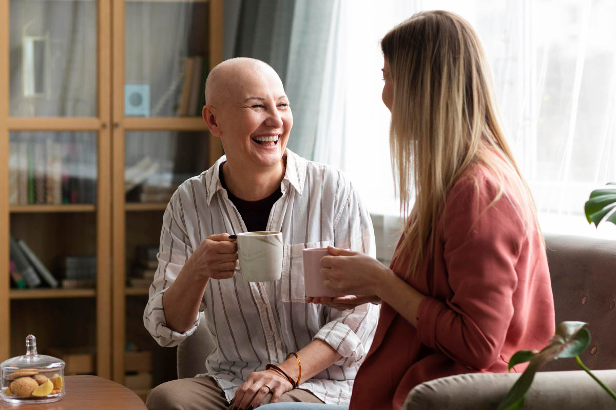 A woman with cancer sharing a drink with a colleague