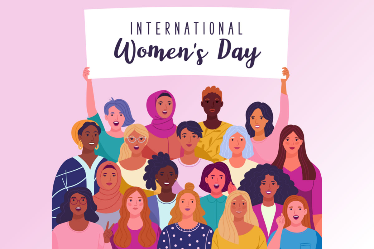 An illustration showing a diverse group of women celebrating international women's day. They are holding a banner above their heads that reads 'International Women's Day'.